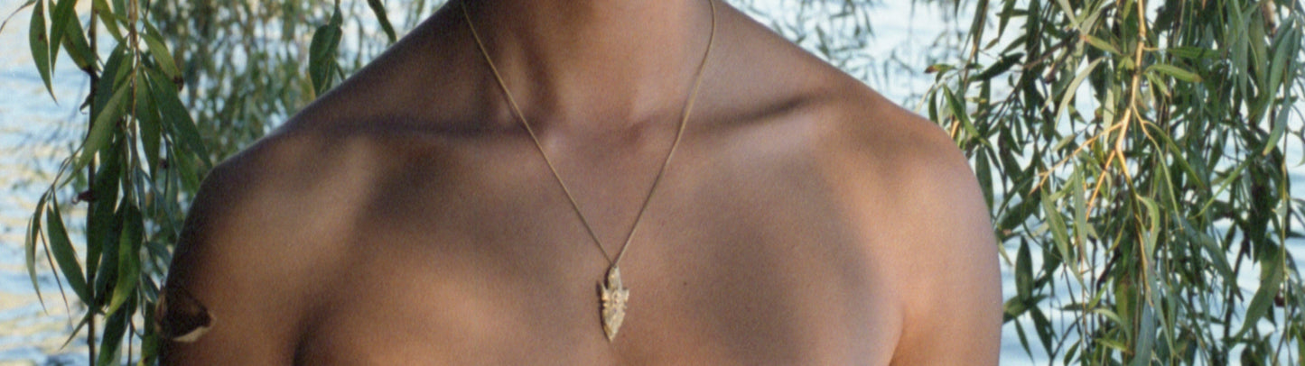 A pendant made from the cast of a neolithic era arrowhead. It is set with ruby, amethyst, pink and yellow sapphires on a curb-link chain. Handmade by Violette Stehli. Photo Angélique Stehli.