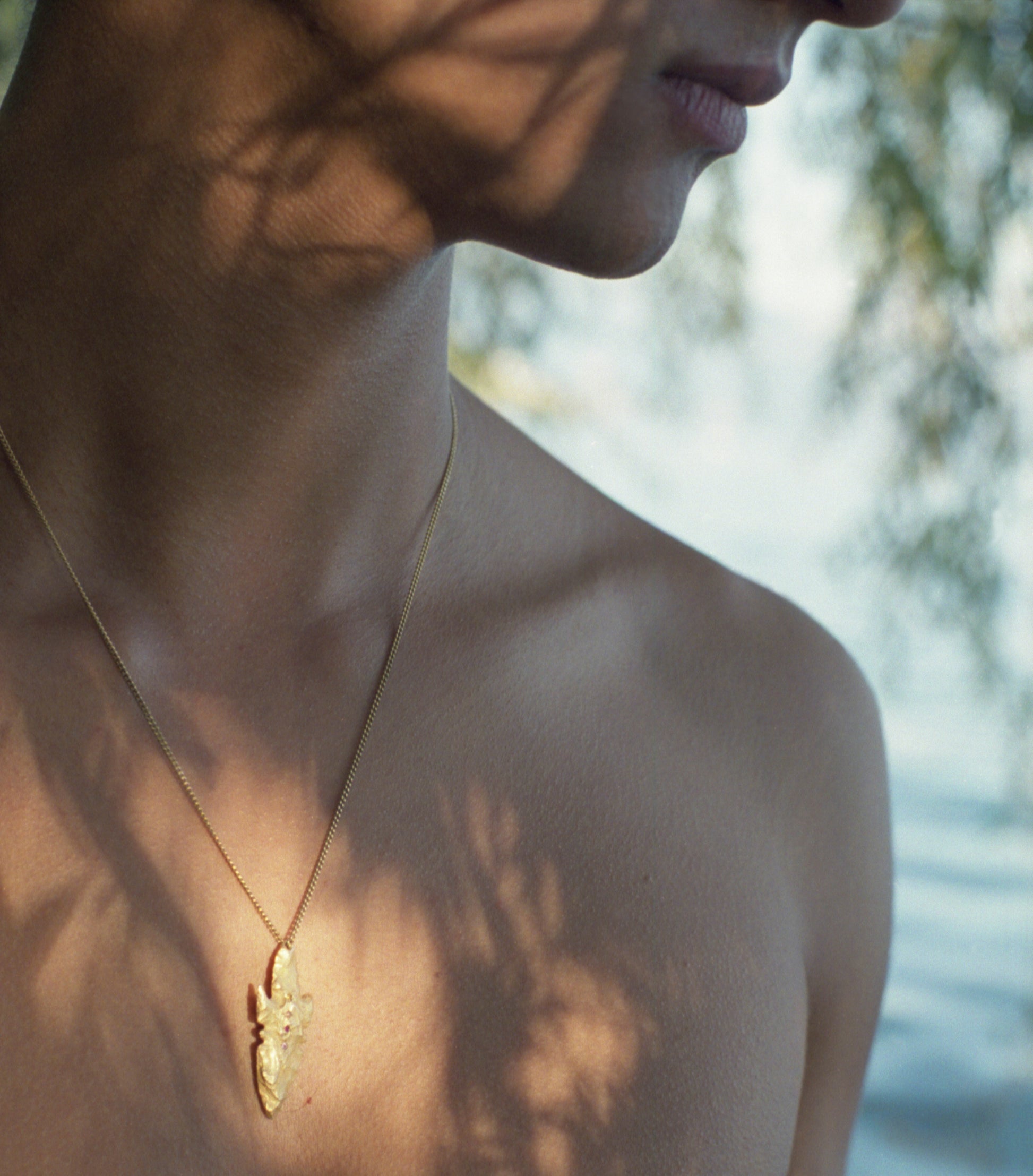 A pendant made from the cast of a neolithic era arrowhead. It is set with ruby, amethyst, pink and yellow sapphires on a curb-link chain. Handmade by Violette Stehli. Photo Angélique Stehli.
