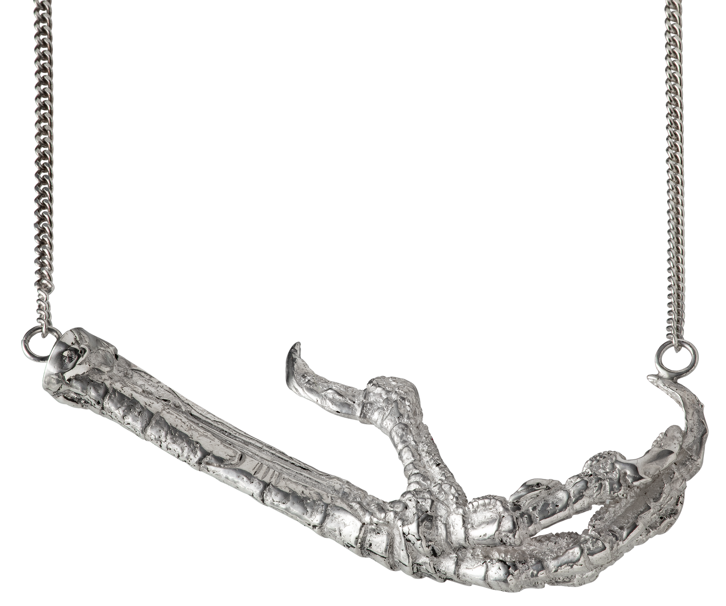 A necklace cast from a crows foot and set with rubies by Violette Stehli. The necklace is a choker on a curb-link chain.