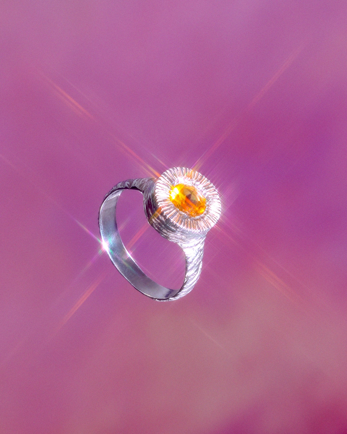 A hand sculpted, textured sterling silver ring set with a citrine. Made using the lost wax casting technique by Violette Stehli. Photo by Julia Grandperret.