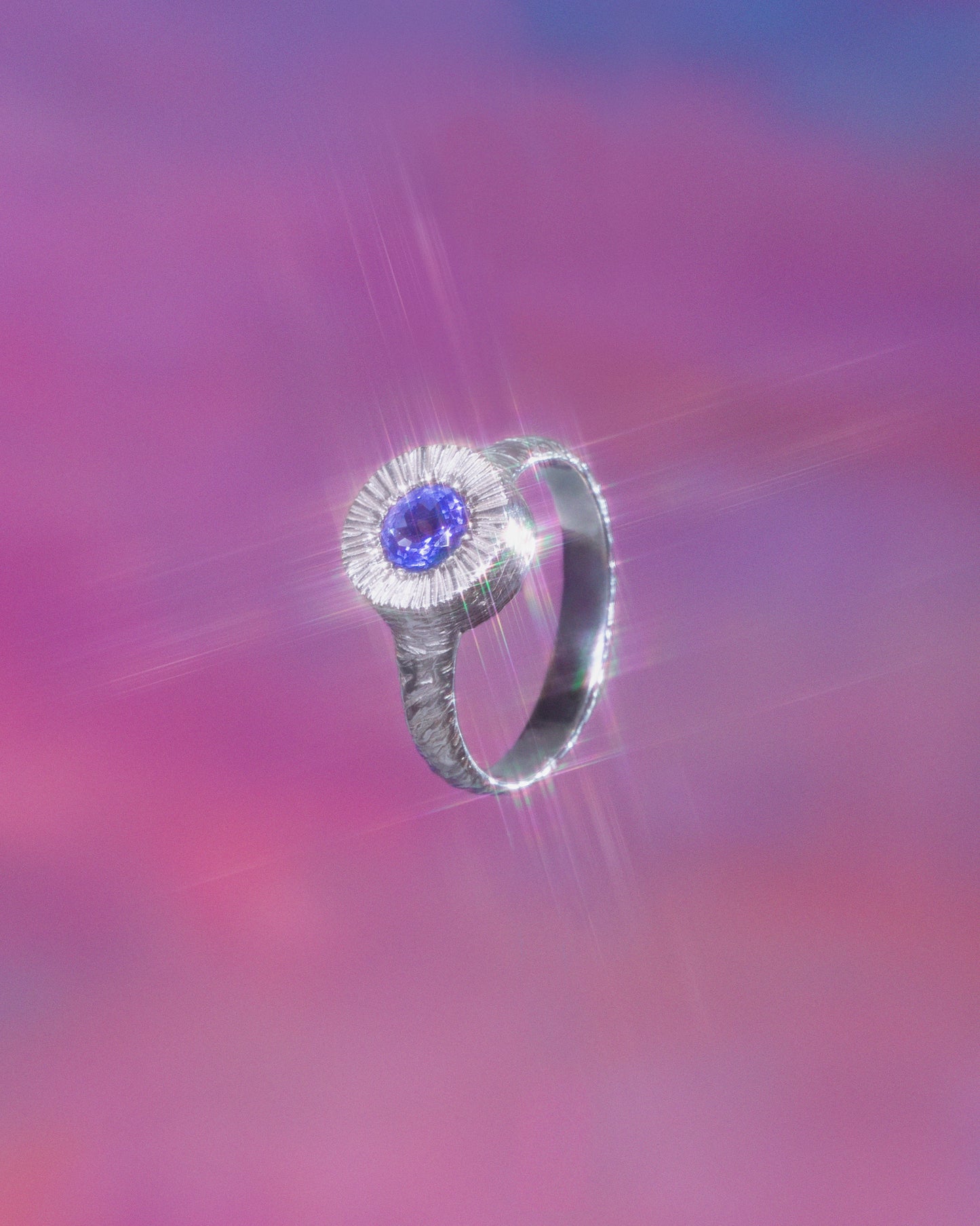A hand sculpted, textured sterling silver ring set with a tanzanite. Made using the lost wax casting technique by Violette Stehli. Photo by Julia Grandperret.