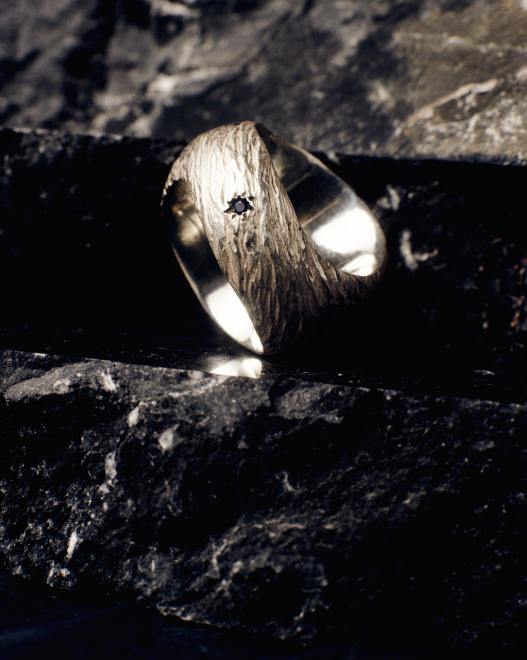 A massive distressed sterling silver and 18-karat gold signet set with opals and sapphires. The ring looks like the surface of the moon annd is hand-sculpted by Violette Stehli. Photo by Daniel Antropik.