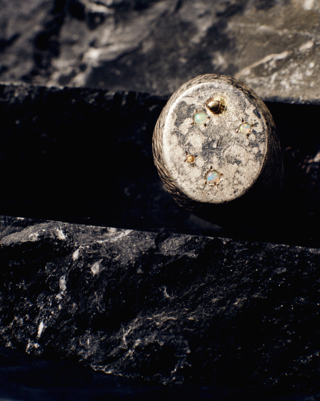 A massive distressed sterling silver and 18-karat gold signet set with opals and sapphires. The ring looks like the surface of the moon annd is hand-sculpted by Violette Stehli. Photo by Daniel Antropik.