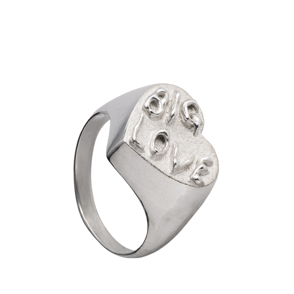 A hand sculpted heart-shaped signet ring made from responsible jewelry council certified sterling silver. The surface of the ring has the words "Big Love" embossed on it in a had-written psychedelic font.
