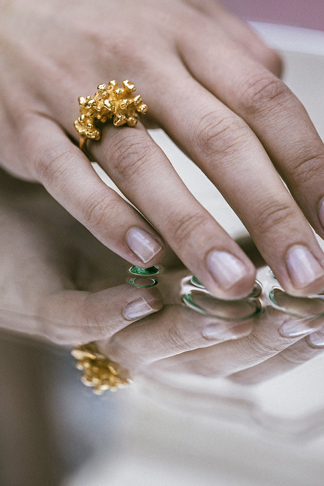 An 18-karat Responsible Jewellery Council certified gold ring. Hanndmade using the lost-wax casting technique. The piece of coral has been reproduced in gold. Handmade by Violette Stehli. Photograph by Cécile Chabert.