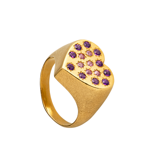 A hand sculpted heart-shaped signet ring made from responsible jewelry council certified 18-karat gold. The surface of the ring is set with amethysts and pink sapphires. Handmade by Violette Stehli.