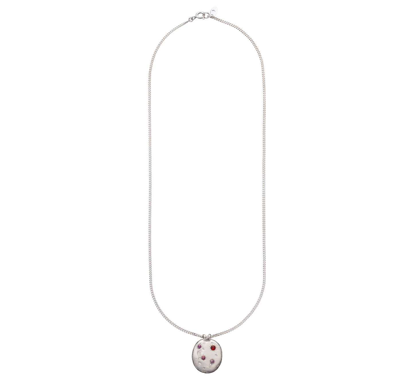 A precious but rough sterling silver medallion set with four precious stones and celestial engravings.
