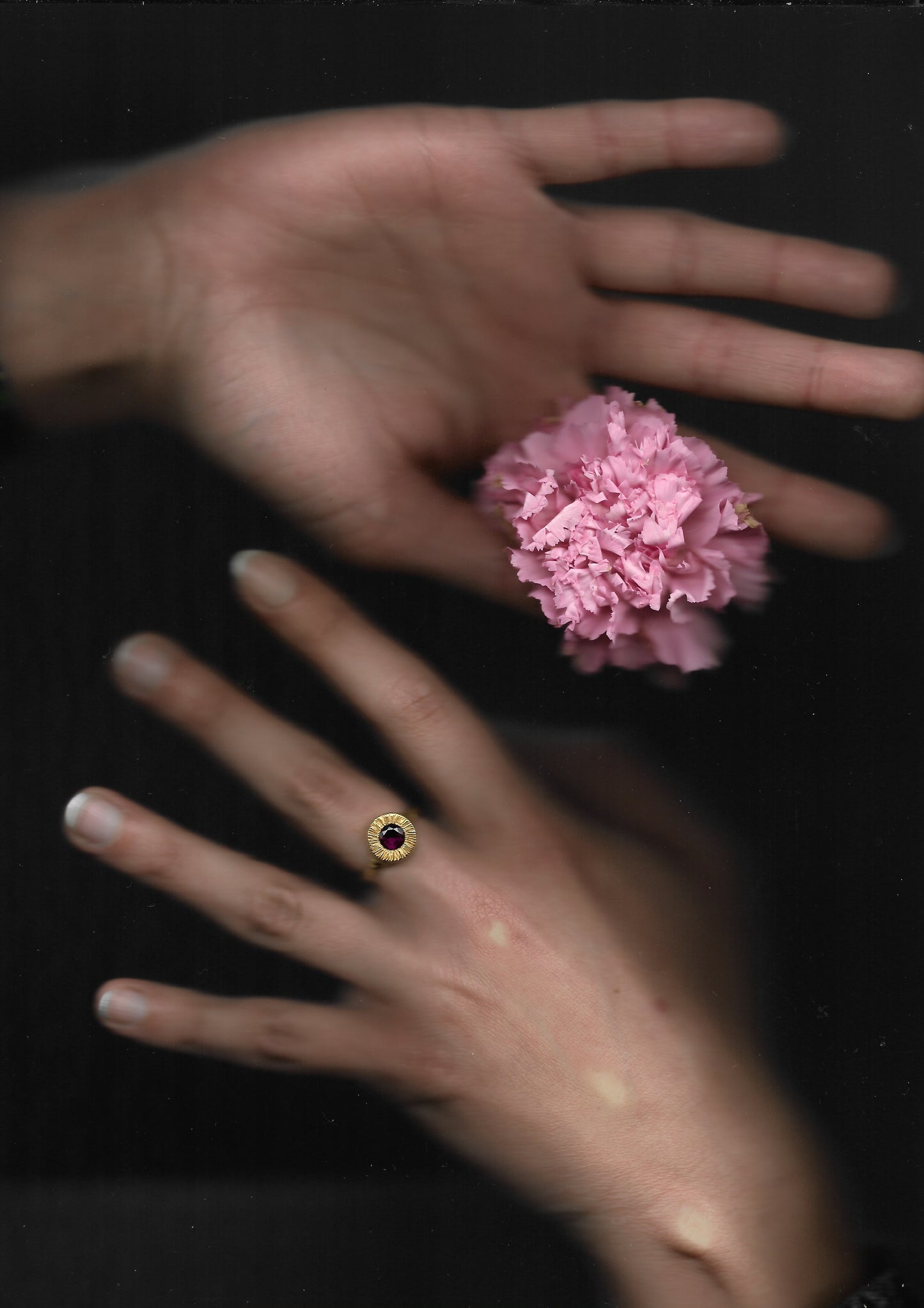 A hand sculpted, textured sterling silver ring set with a rhodolite garnet. Made using the lost wax casting technique by Violette Stehli.