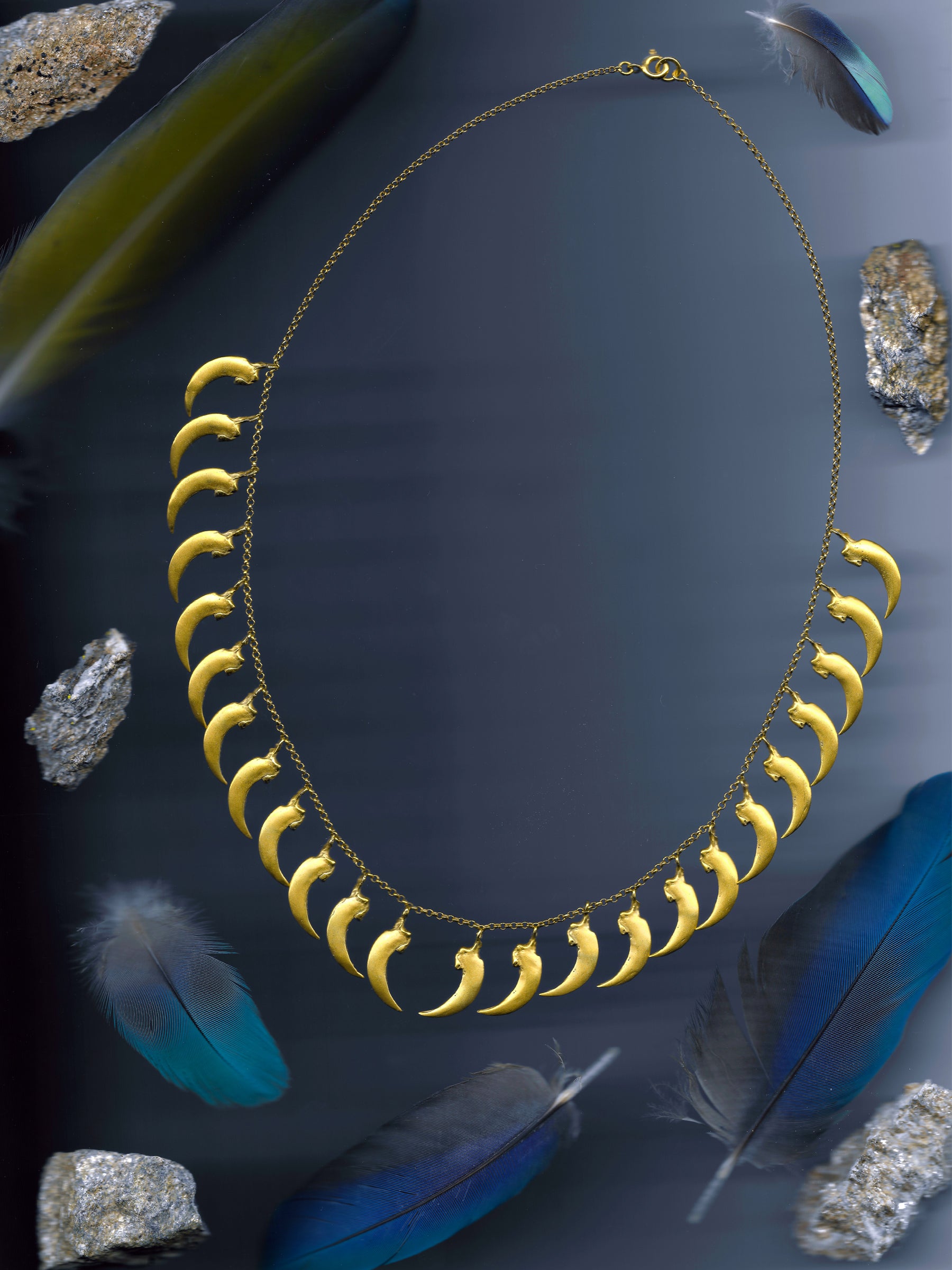 A scanned image of a gold vermeil bat claw necklace made with the lost-wax casting technique. Made by Violette Stehli