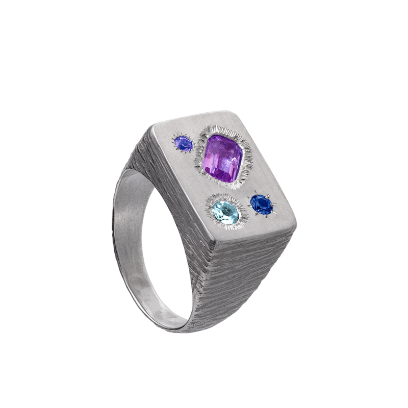 A rough but precious rectangular signet in sterling silver set with four precious stones. Hand sculpted by Violette Stehli.