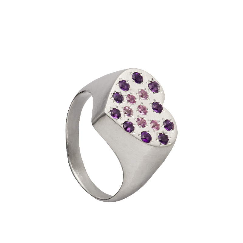 A hand sculpted heart-shaped signet ring made from responsible jewelry council certified sterling silver. The surface of the ring is set with amethysts and pink sapphires. Handmade by Violette Stehli.