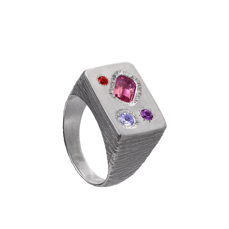 A rough but precious rectangular signet in sterling silver set with four precious stones. Hand sculpted by Violette Stehli.