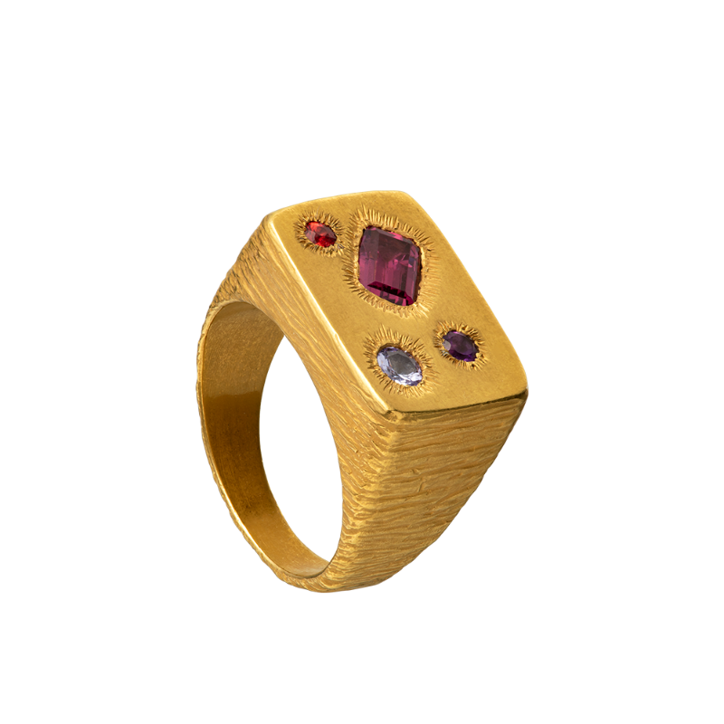A rough but precious rectangular signet in 18-karat gold set with four precious stones. Hand sculpted by Violette Stehli.