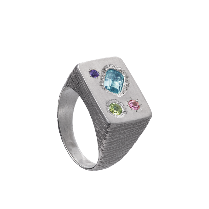 A rough but precious rectangular signet in sterling silver set with four precious stones. Hand sculpted by Violette Stehli.