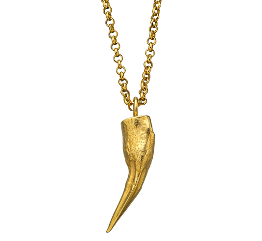 An 18-karat pendant charm cast from a pike tooth using the lost wax casting technique. The pendant is on a rolo-link chain. Made by Violette Stehli.