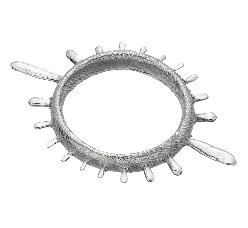 A colossal sterling silver bangle adorned with sea urchin spines and delicate granulation details evoking ancient Etruscan jewelry.