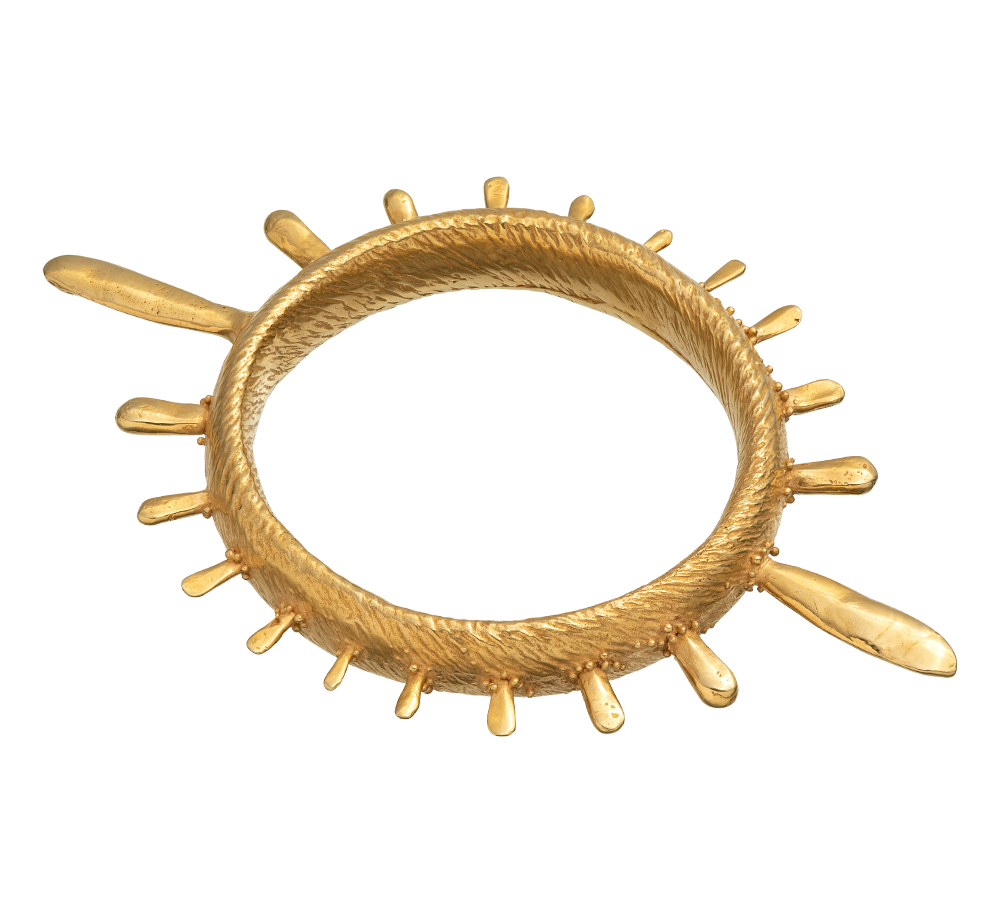 A colossal gold vermeil bangle adorned with sea urchin spines and delicate granulation details evoking ancient Etruscan jewelry.