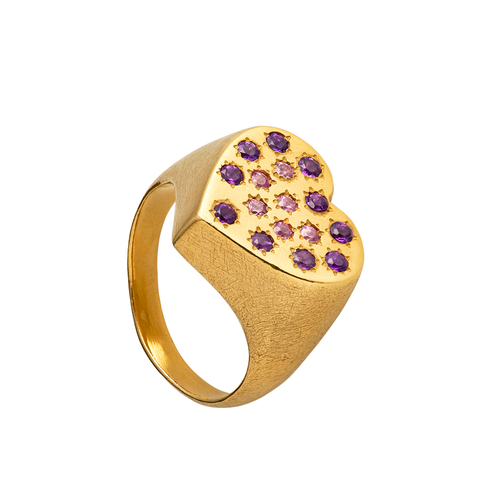 A hand sculpted heart-shaped signet ring made from responsible jewelry council certified 18-karat gold. The surface of the ring is set with amethysts and pink sapphires. Handmade by Violette Stehli.