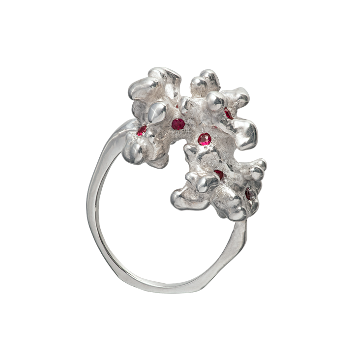 A sterling silver ring cast from a fragment of coral and set with 10 rubies. Made by Violette Stehli.