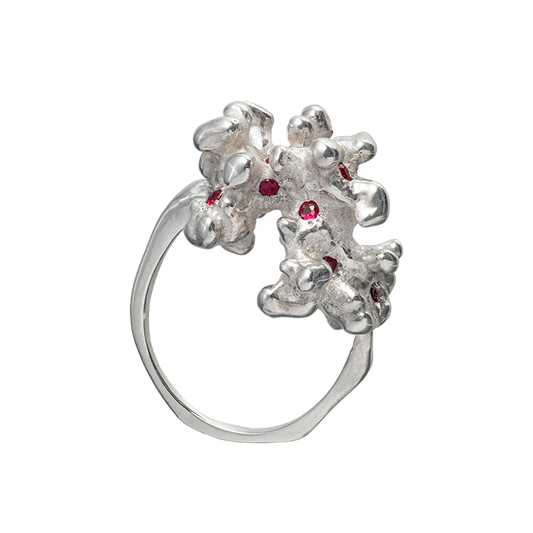 A sterling silver ring cast from a fragment of coral and set with 10 rubies. Made by Violette Stehli.