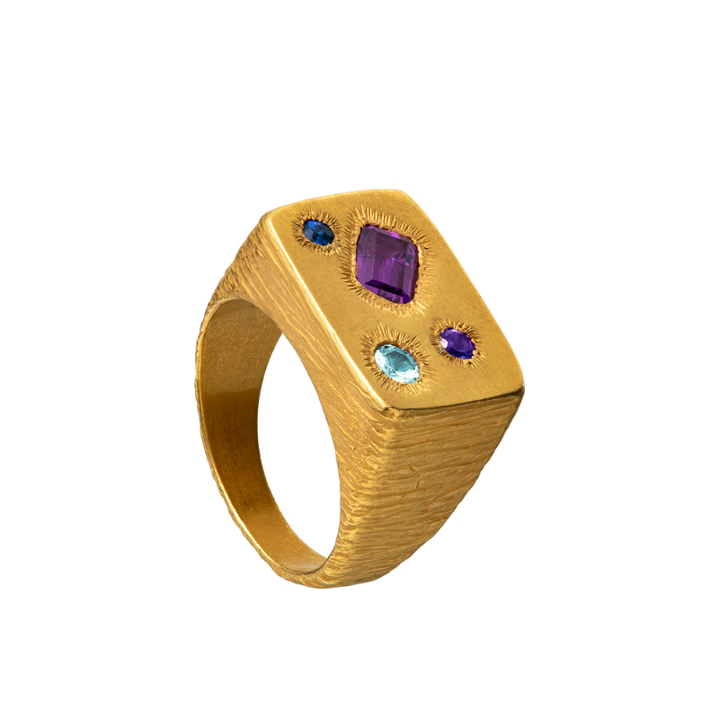 A rough but precious rectangular signet in 18-karat gold set with four precious stones. Hand sculpted by Violette Stehli.