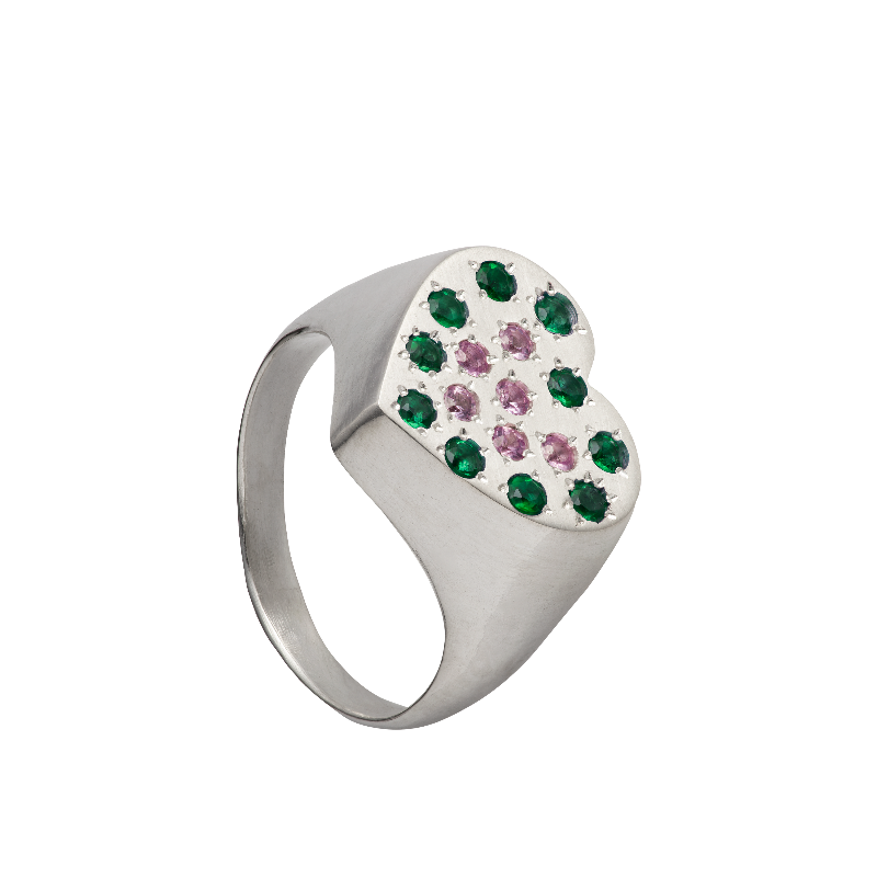 A hand sculpted heart-shaped signet ring made from responsible jewelry council certified sterling silver. The surface of the ring is set with emeralds and pink sapphires. Handmade by Violette Stehli.