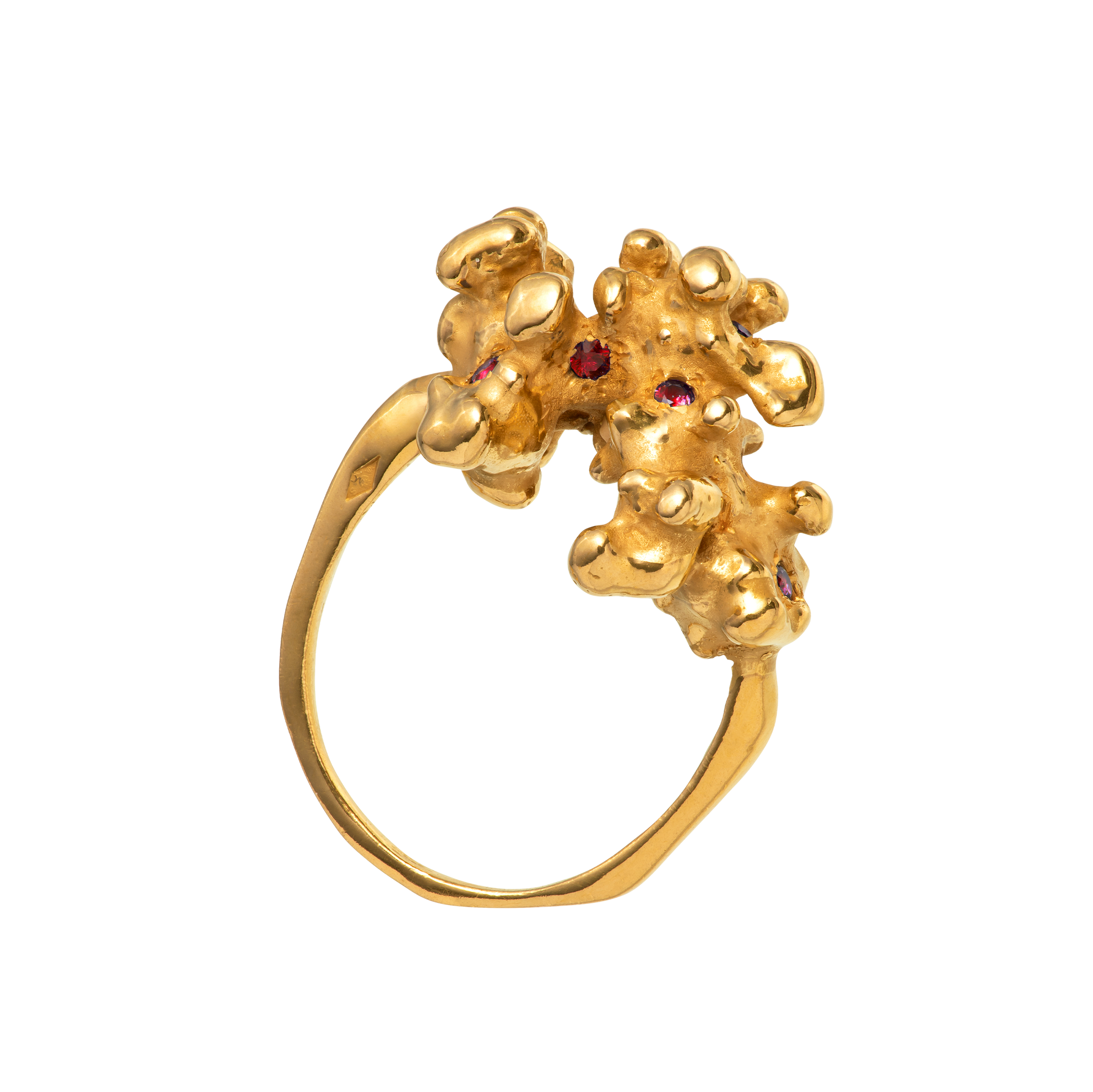 A gold ring made from a cast of a fragment of coral as set with 10 rubies. Handmade by Violette Stehli.