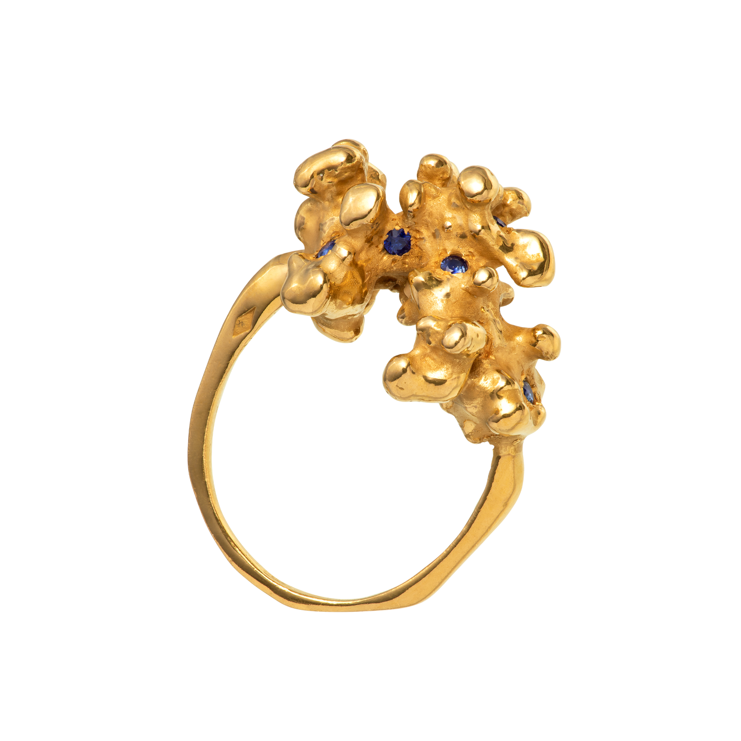A gold ring made from a cast of a fragment of coral as set with 10 blue sapphires. Handmade by Violette Stehli.