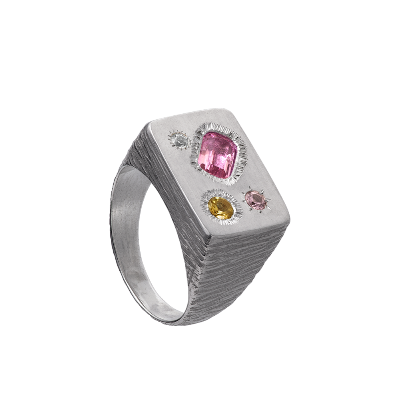 A rough but precious rectangular signet in sterling silver set with four precious stones. Hand sculpted by Violette Stehli.
