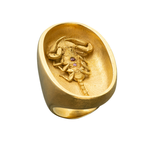 A large gold ring made by Violette Stehli featuring a scorpion set with sapphire and garnet. The ring is made using the lost wax casting process.