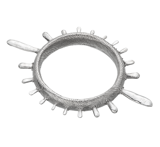 A colossal sterling silver bangle adorned with sea urchin spines and delicate granulation details evoking ancient Etruscan jewelry.