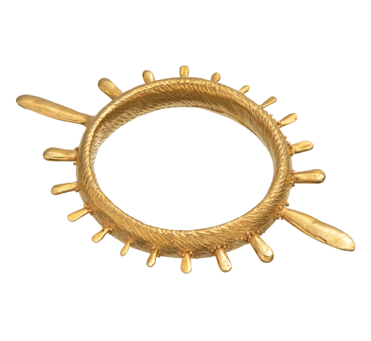 A colossal gold vermeil bangle adorned with sea urchin spines and delicate granulation details evoking ancient Etruscan jewelry.